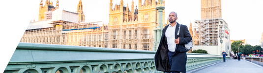 Expatriates hero image of man with backpack walking through city