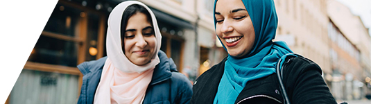 Global pay data hero image of two women wearing headscarves